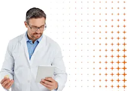 Male pharmacist reviews drug information on a tablet