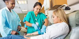 two nurse attending to a patient
