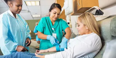 two nurse attending to a patient