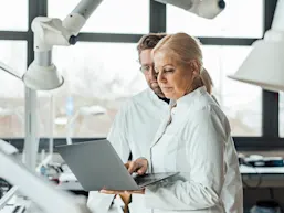 Photo portraying two scientists at a laptop (Photo credit: Westend61 via Getty Images)