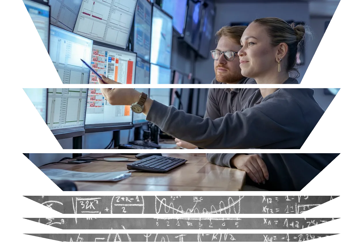 Scientist and Engineer inspecting data on screens in a control room