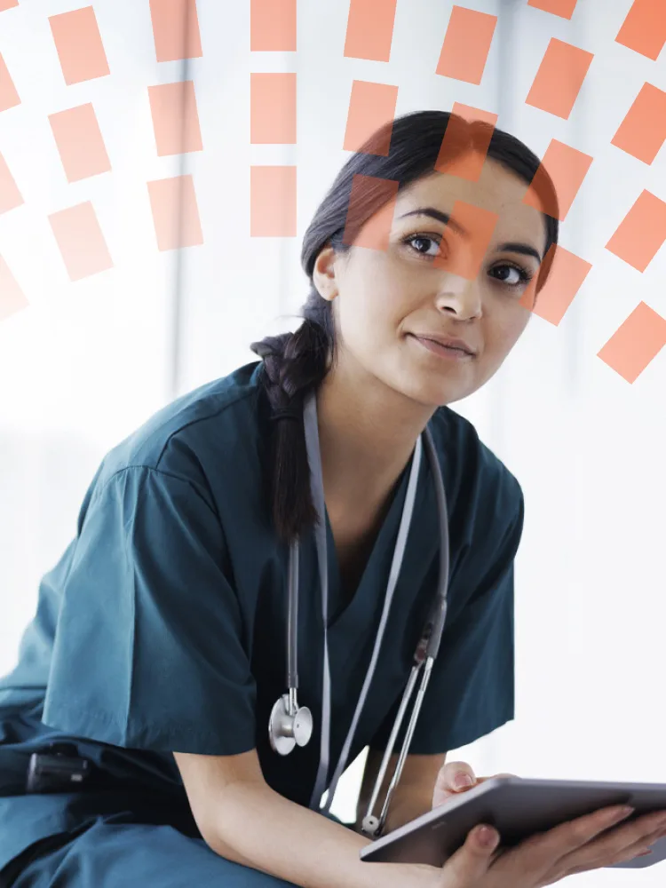 Female doctor in scrubs looking at digital tablet