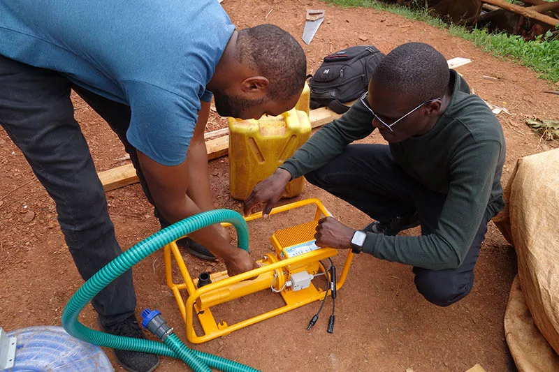 Solar energy can make a massive difference to people living in areas where electricity is unavailable or unreliable. Here, workers field test a solar water pump in Rwanda.