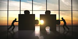 Two men pushing two pieces of a puzzle together