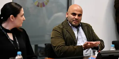 Niheer Dasandi speaking at table