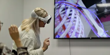 Elsevier's Global Medical Education team works on Complete HeartX, designed for Apple Vision Pro. The woman closest to the screen is wearing the Apple Vision Pro headset. 