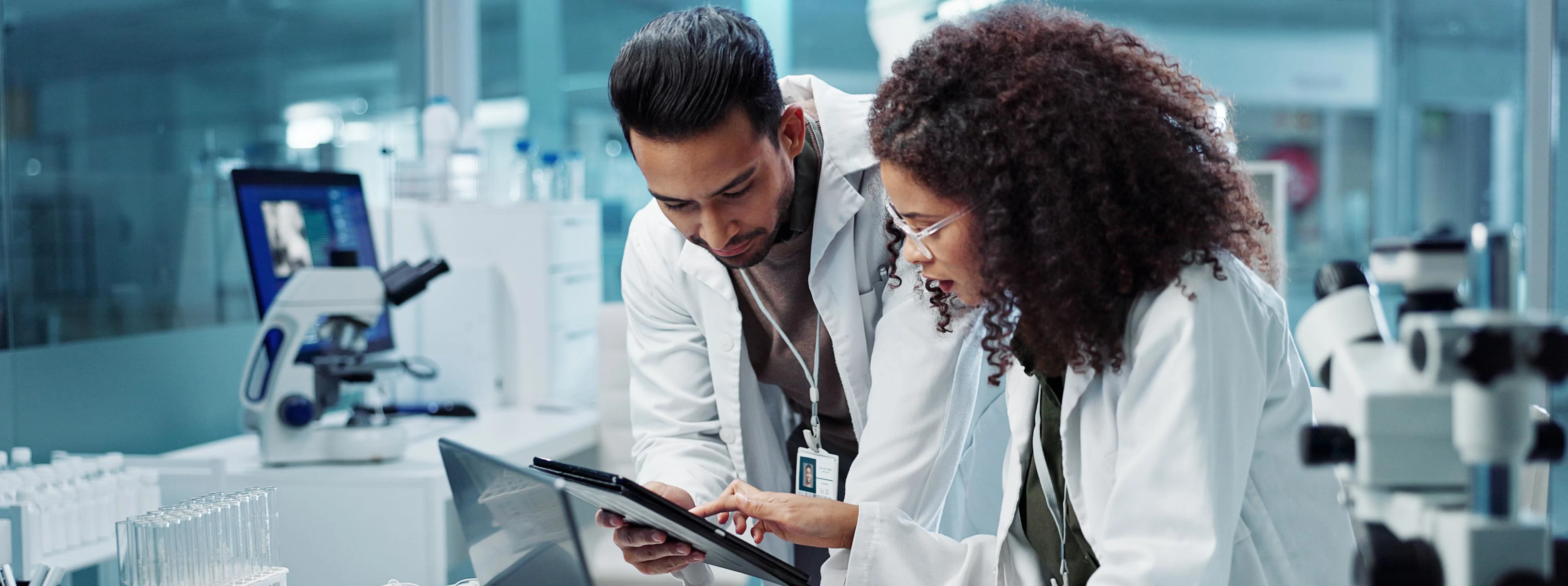 Science, teamwork and scientist with tablet in laboratory for communication, pharmaceutical review or planning. Employees, collaboration and technology for research, discussion and digital analysis