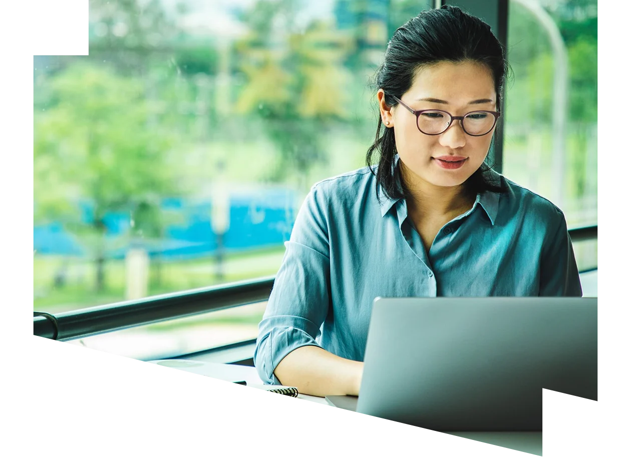 Asian female working on a laptop remotely