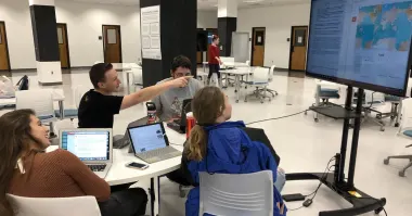 Group of students collaborating on a digital project 