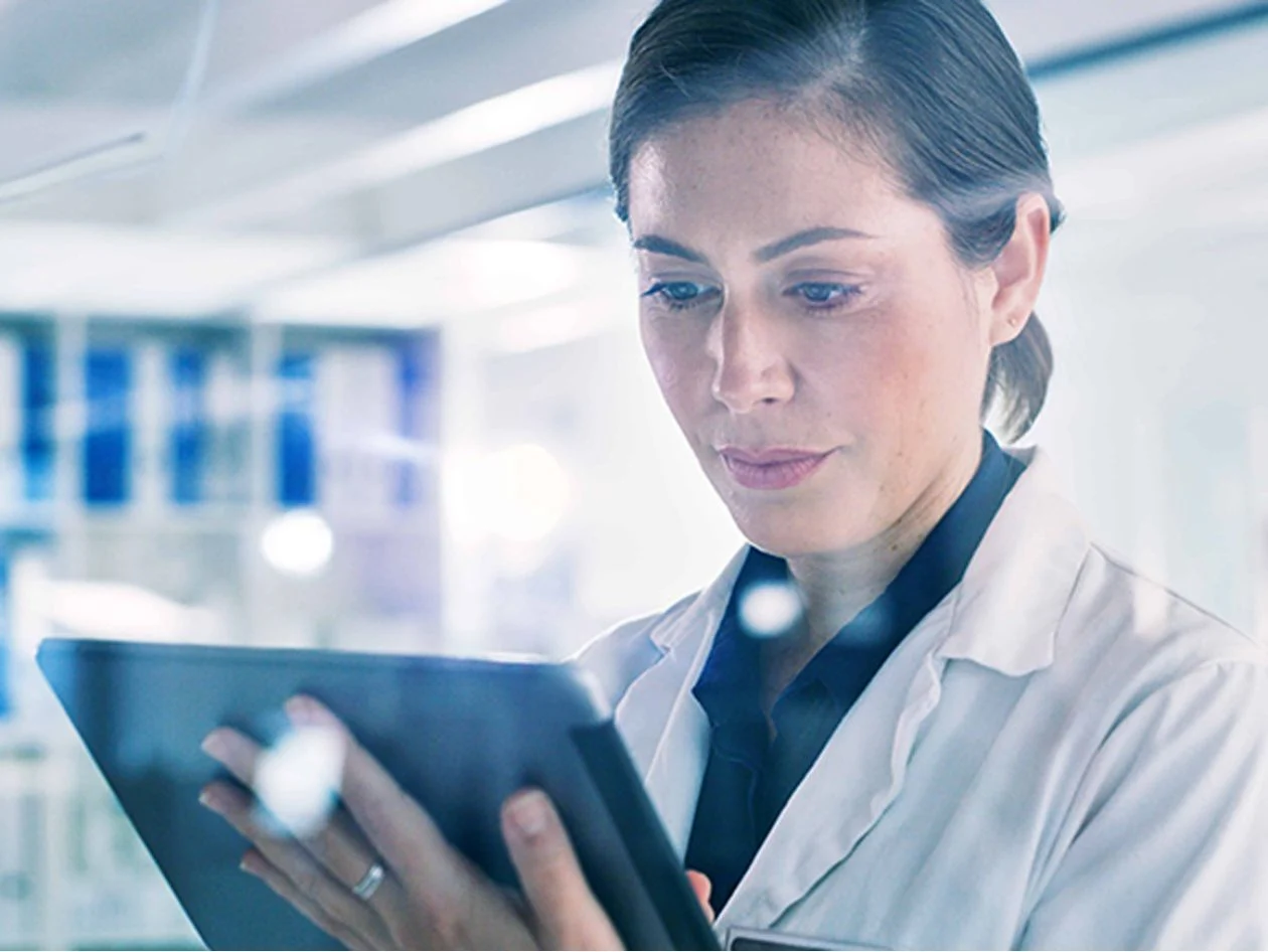 female-scientist-using-tablet-checking-notes