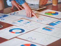 Hand pointing at pages of metrics