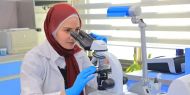 Dr Haneen Dwaib with a microscope in her lab at Palestine Ahliya University, where she is Chairwoman of the Clinical Nutrition and Dietetics department.