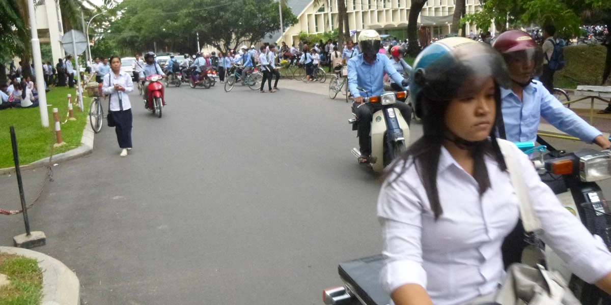 Students riding a motor bike in Cambodia Colleges