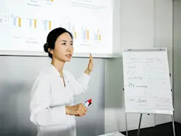 Photo depicting a researcher giving a presentation (Tom Werner/DigitalVision via Getty Images)