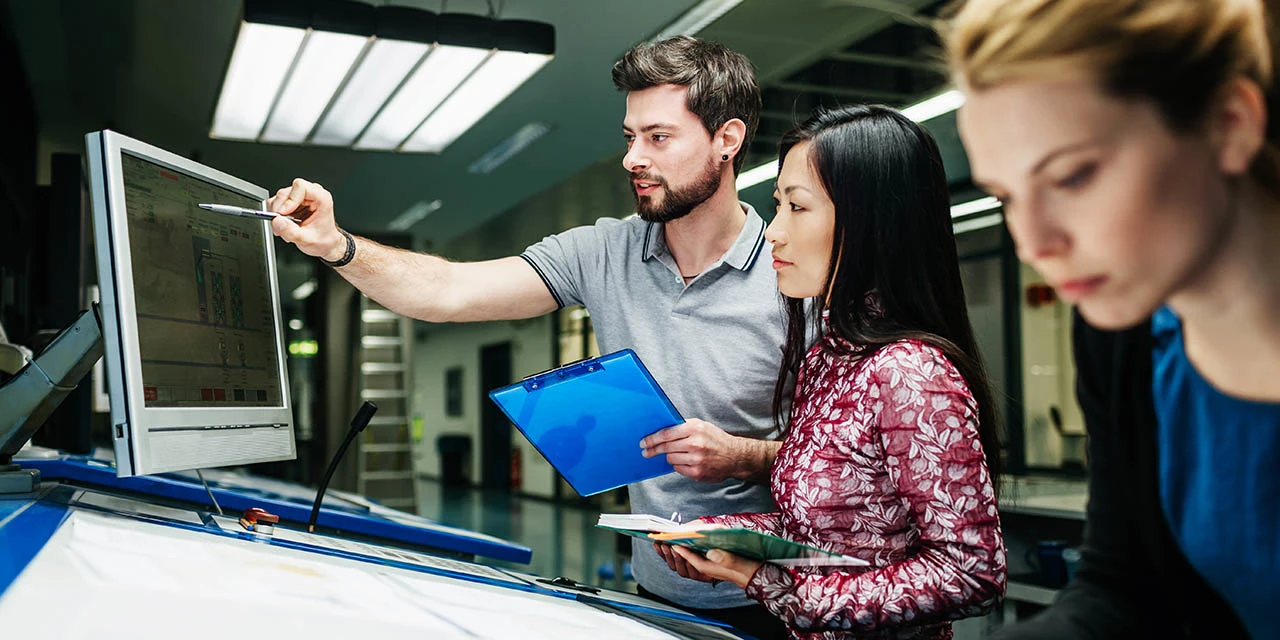 Photo depicting engineering team collaborating (TommL/E+ via Getty Images)