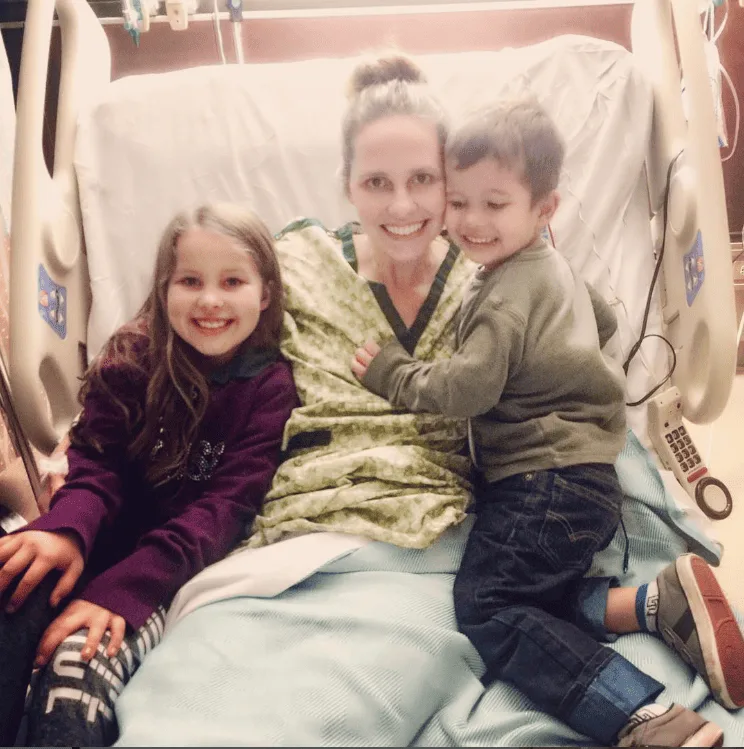 Melody in the hospital with her children.