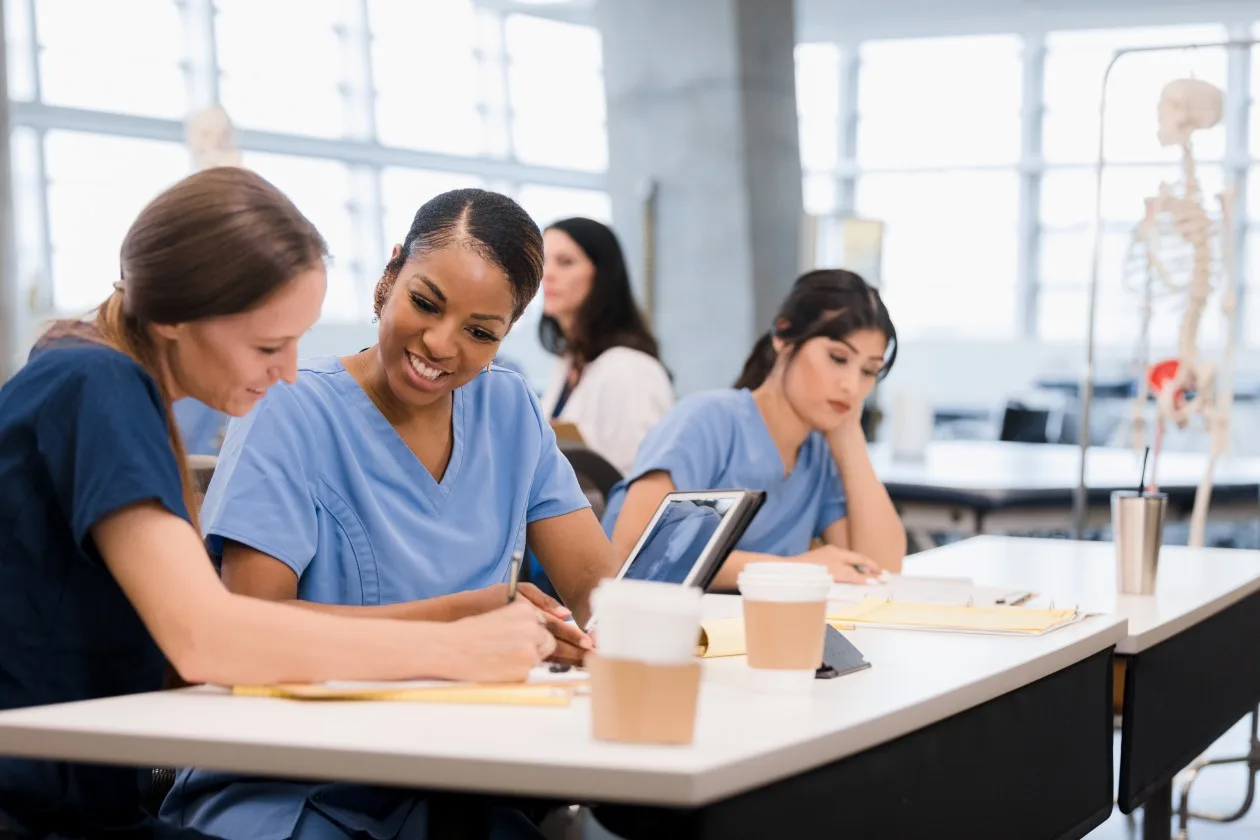 Three african american doctors reviewing ipad