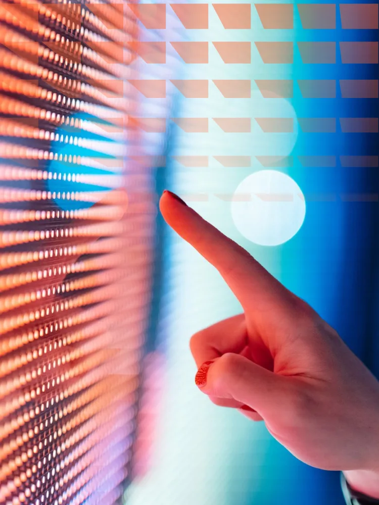 Close-up of female hand touching illuminated digital display in the dark