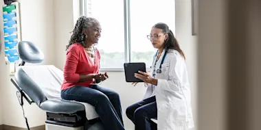 Stock photo depicting a female physician showing information on a tablet to a female patient. (Source: MoMo Productions/DigitalVision via Getty Images)