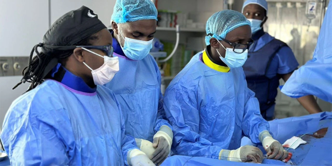 Dr Judy Gichoya (left) supports the interventional radiology medical team in Rwanda, led by Dr Ivan Rukundo. She shared this image with permission in her presentation as one of three panelists on the Lancet Webinar AI and Health Equity in Cancer. 