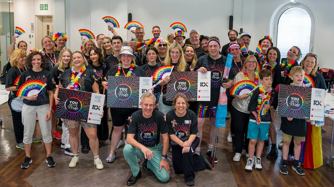 Elsevier CEO Kumsal Bayazit (front row right) and LexisNexis Risk Solutions CEO Mark Kelsey (front row left), pose with RELX Pride colleagues before joining them to walk in the London Pride Parade.