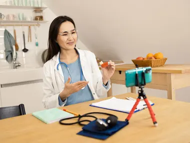 Photo depicting a female doctor making a home video (Mix Media/iStock via Getty Images)