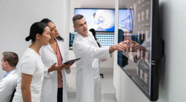 Radiologists viewing xrays on large screen