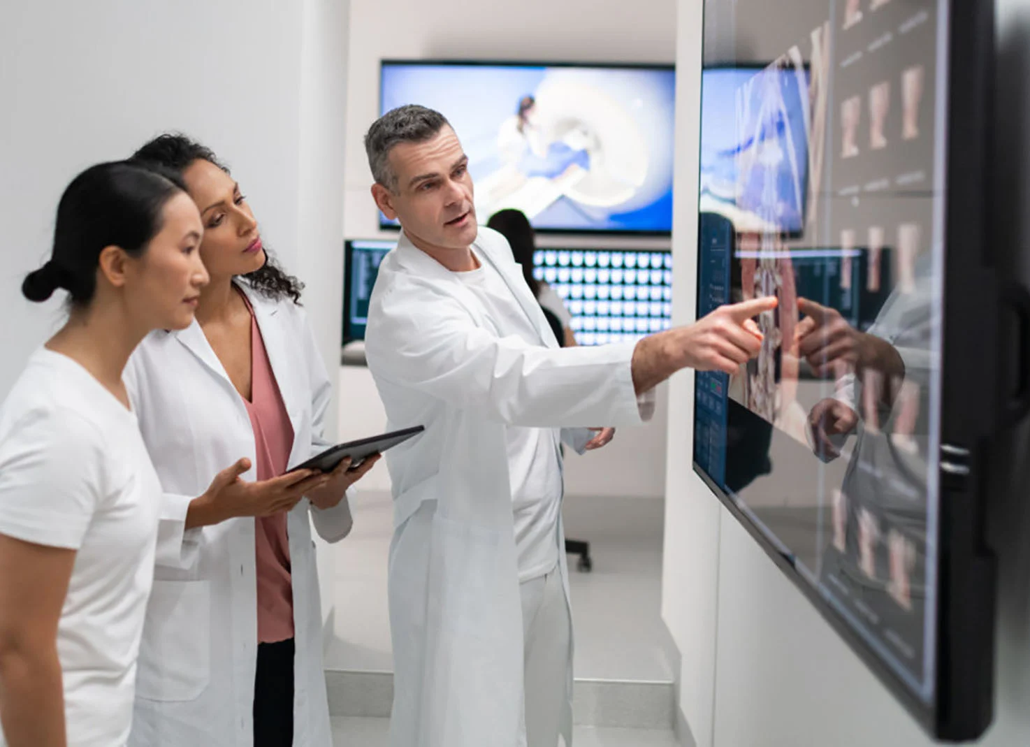 Radiologists viewing xrays on large screen