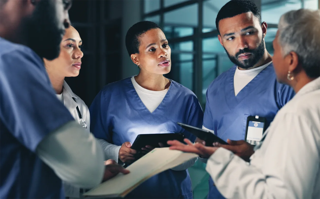 Nurse in foreground with physician colleagues in abstract