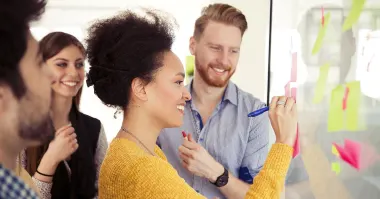 Group of young creative people collaborating in modern office