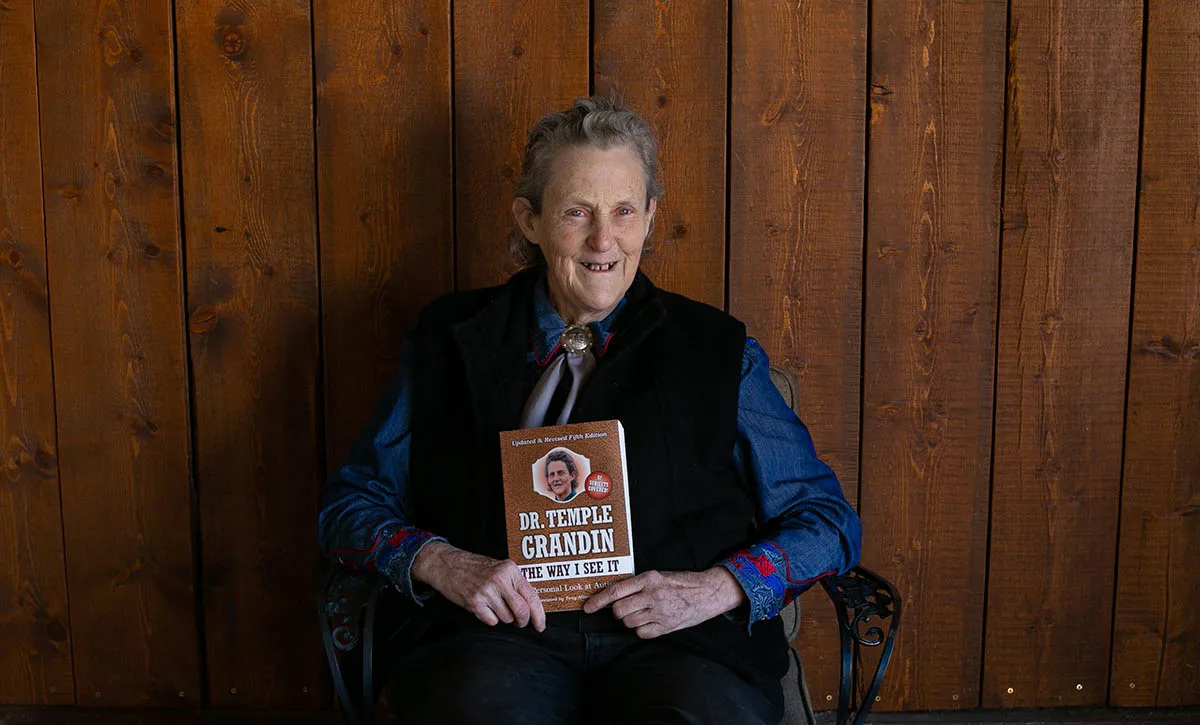 Temple Grandin holding a book