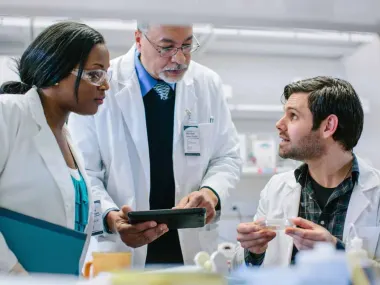 Clinicians meeting in a lab