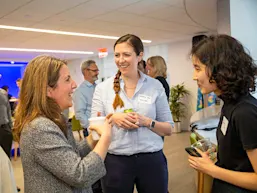 Elsevier CEO Kumsal Bayazit (left) talks with technology colleagues after a townhall in the New York office. (Photo by Alison Bert)