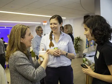 Elsevier CEO Kumsal Bayazit (left) talks with technology colleagues after a townhall in the New York office. (Photo by Alison Bert)