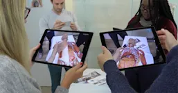 Group of people looking at tablet 
