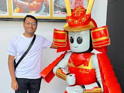 HM Kamrul Hassan poses with a humanoid at Hajime Robot Restaurant in Bangkok, Thailand