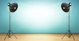 Two spotlights shining on a blue wall