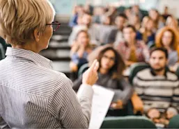 College students listening to their professor in a lecture hall