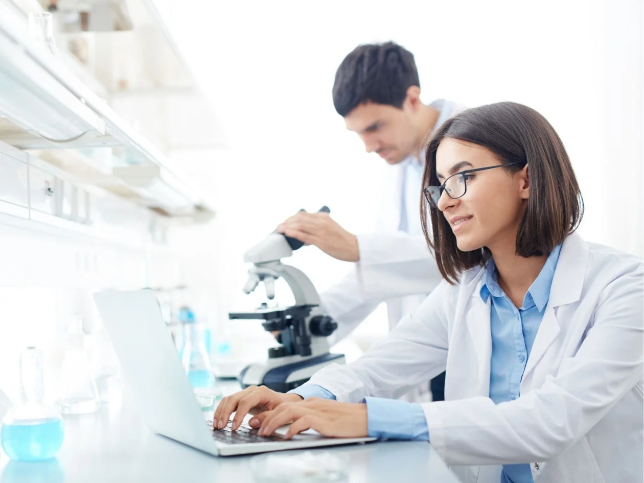 Chemist using a laptop