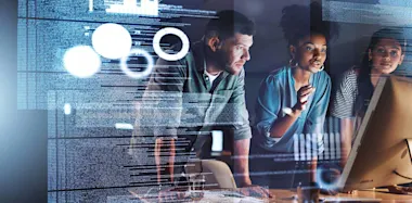 Three people looking at a computer