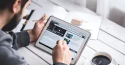 Man browsing the internet on a digital tablet