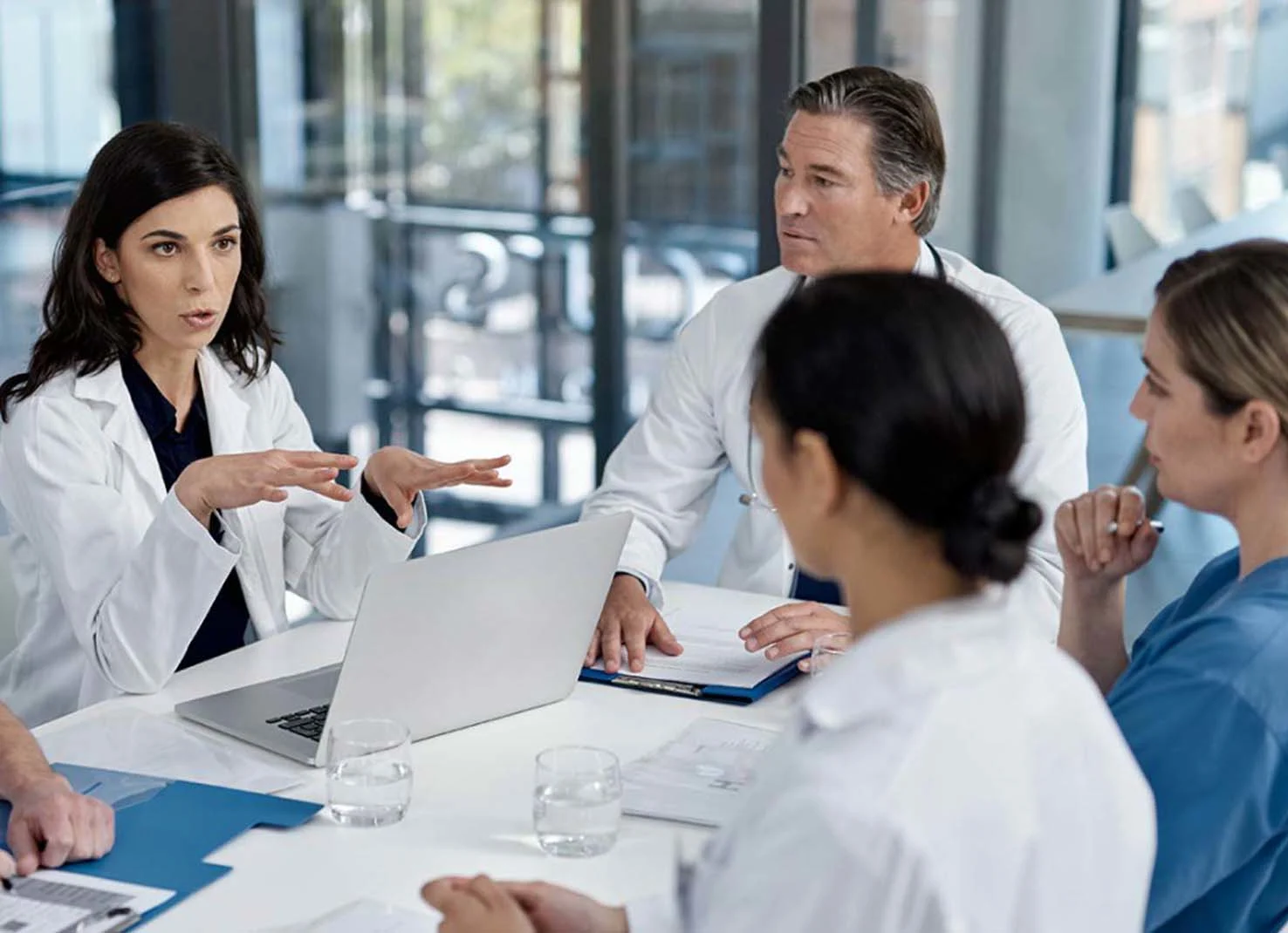 Four health professionals around conference table