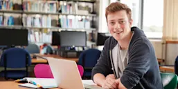 Academic student in library with laptop