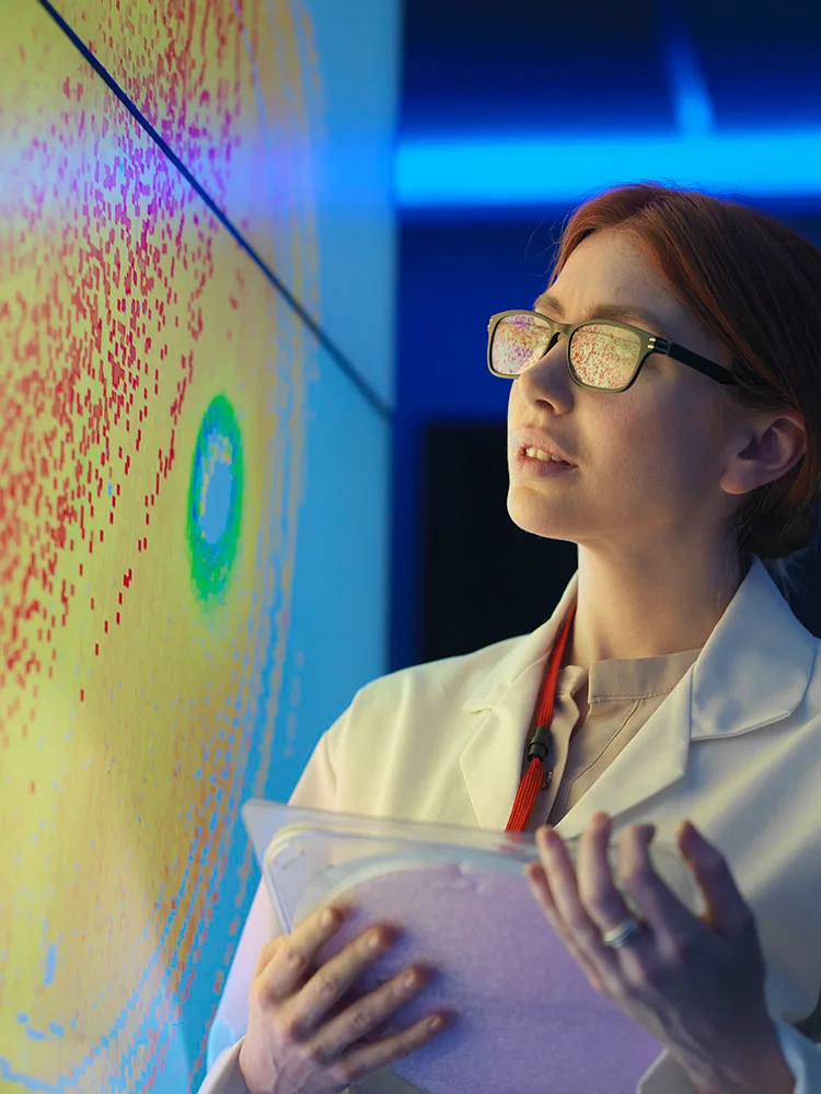 Woman looking at AI-generated visuals on a computer screen