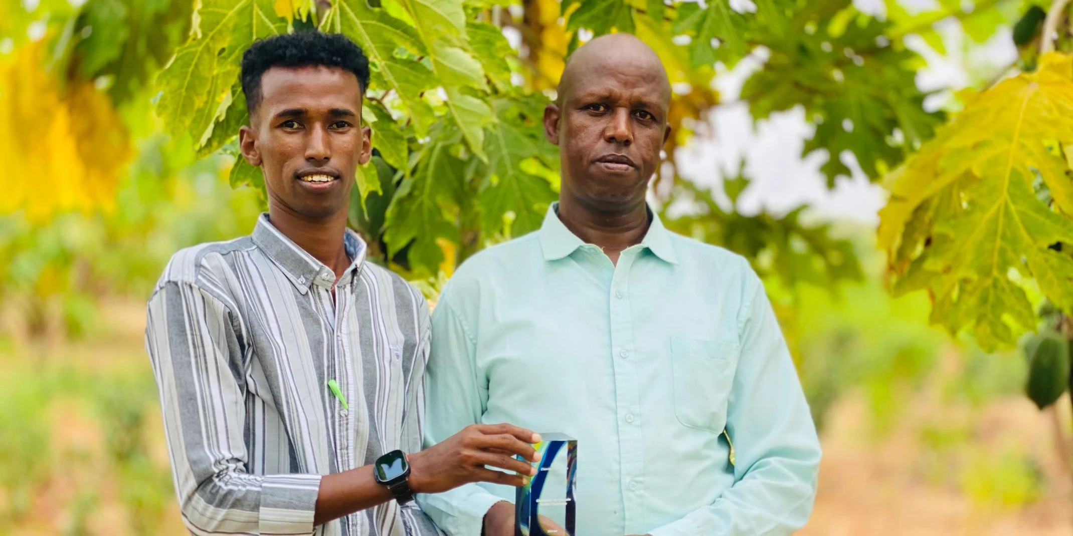 Two men holding an Elsevier Foundation award