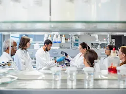 Photo depicting chemists in a lab (Source: sanjeri/E+ via Getty Images)