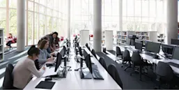 Students researching at computers in library