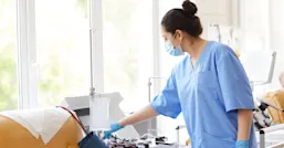 Female nurse checking monitoring equipment
