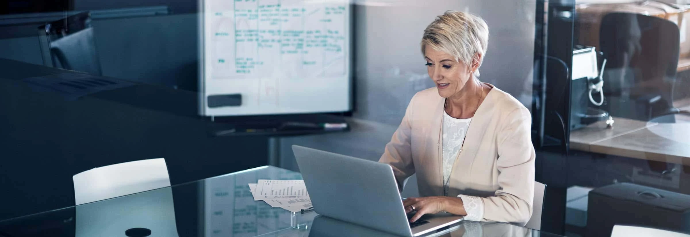 Mature businesswoman working on a laptop in an office