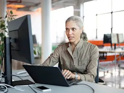 Image depicting a woman using AI on a computer (Photo: JohnnyGreig/E+ via Getty Images)